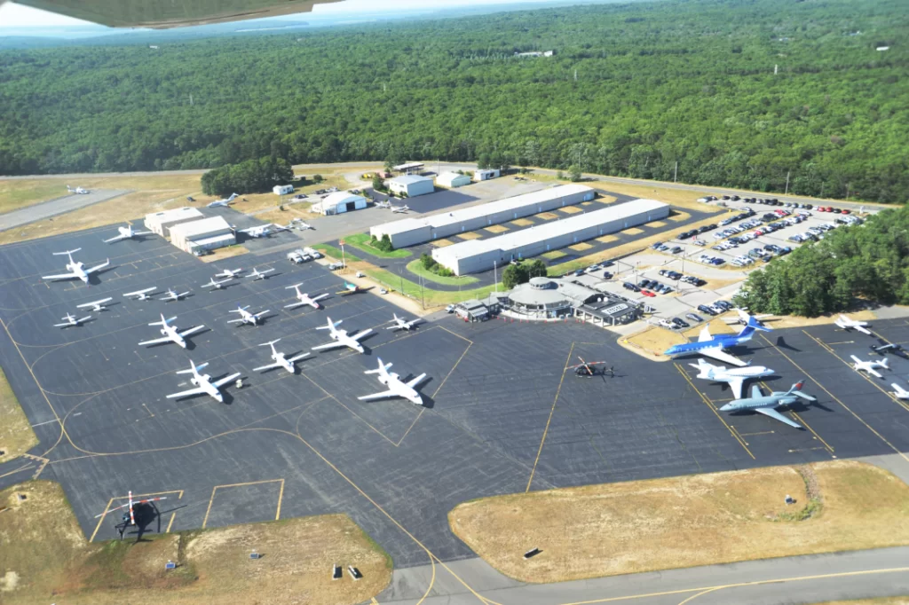 Aerial view of an airport with private jets and terminal buildings