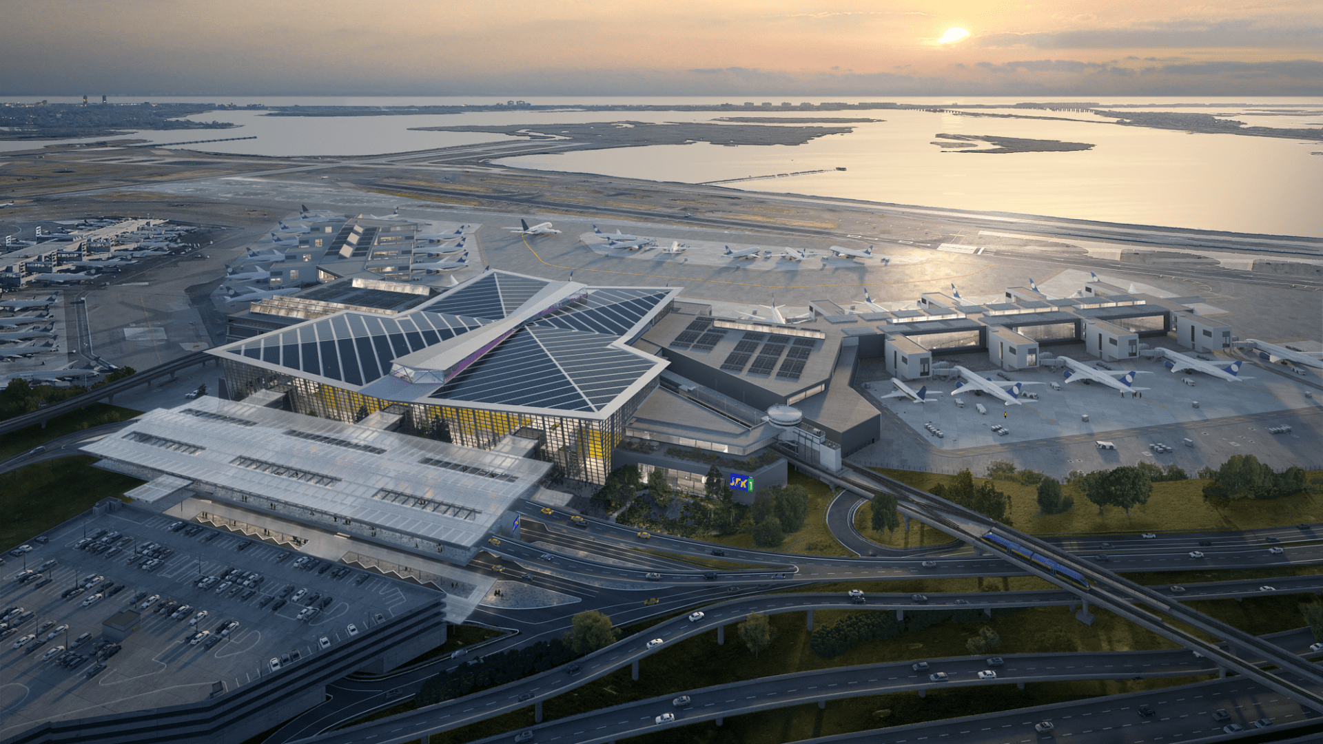 Aerial view of an international airport with airplanes at gates near the coastline